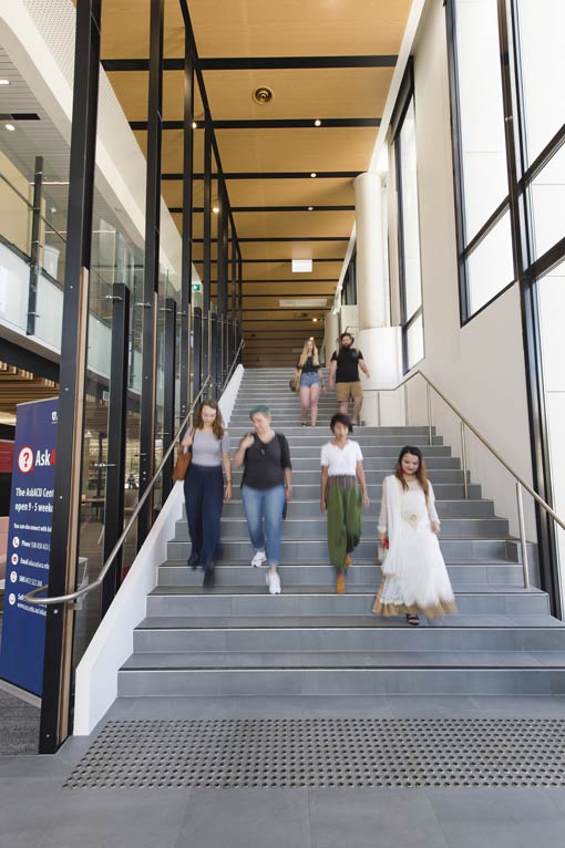 Students descending stairs on campus.