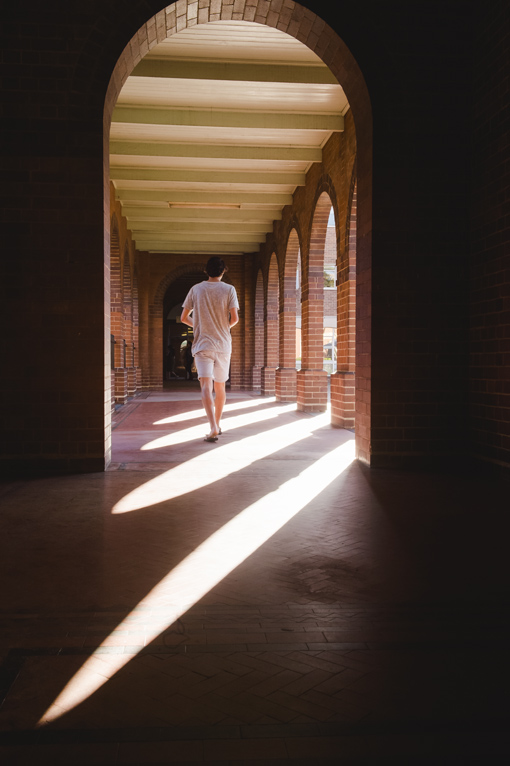 Man walking through a corridor.